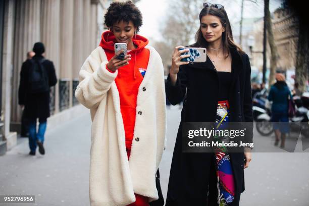 Brazilian models Samile Bermannelli, Linda Helena take photos of photographers on their cell phones after the Elie Saab show on January 24, 2018 in...