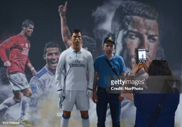 Visitor posses for a photo with a Cristiano Ronaldo waxwork inside the CR7 Museum located in Funchal seafront, on the island of Madeira, where...