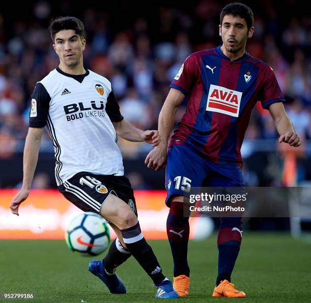 Carlos Soler of Valencia CF competes for the ball with Cote of SD Eibar during the La Liga game between Valencia CF and SD Eibar at Mestalla on April...