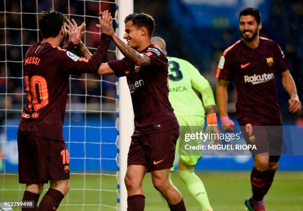 Barcelona's Argentinian forward Lionel Messi celebrates with Barcelona's Brazilian midfielder Philippe Coutinho during the Spanish league football...