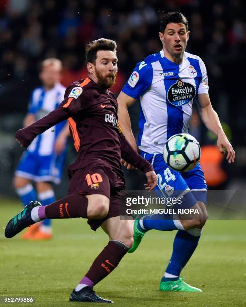 Barcelona's Argentinian forward Lionel Messi challenges Deportivo La Coruna's Swiss defender Fabian Schar during the Spanish league football match...