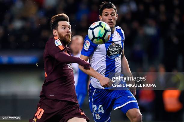 Barcelona's Argentinian forward Lionel Messi challenges Deportivo La Coruna's Swiss defender Fabian Schar during the Spanish league football match...