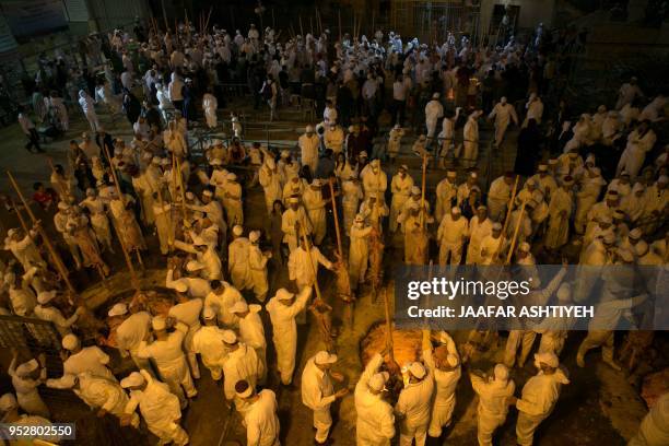 Samaritans take part in the traditional Passover sacrifice ceremony, where sheep and goats are slaughtered, at Mount Gerizim near the northern West...