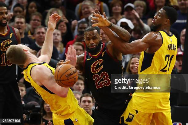 LeBron James of the Cleveland Cavaliers battles for the ball with Thaddeus Young and Domantas Sabonis of the Indiana Pacers during the second half of...