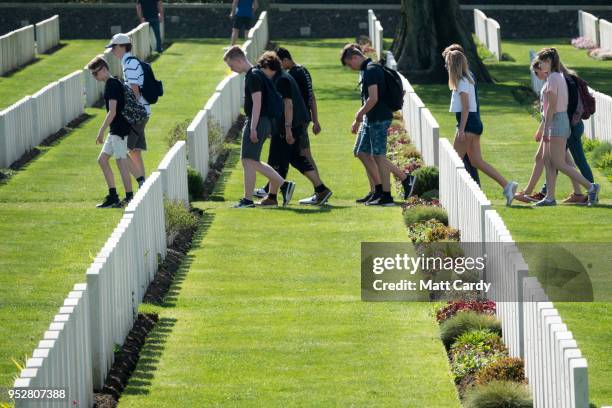 Students pass headstones of fallen soldiers from the First World War are seen at the Tyne Cot Cemetery, the largest Commonwealth War Graves...