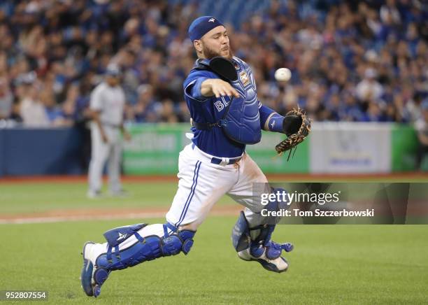 Russell Martin of the Toronto Blue Jays makes the play and throws out the baserunner in the ninth inning during MLB game action against the Texas...