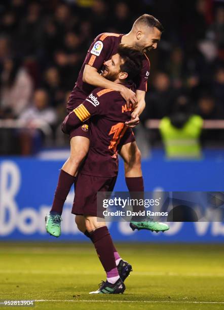 Lionel Messi of Barcelona celebrates as he scores his sides fourth goal with Jordi Alba during the La Liga match between Deportivo La Coruna and...