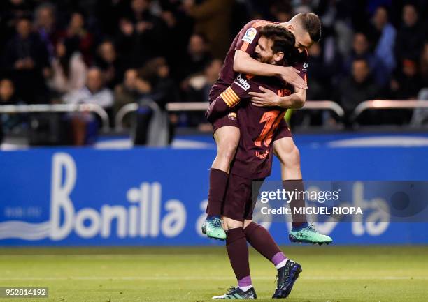 Barcelona's Argentinian forward Lionel Messi celebrates with Barcelona's Spanish defender Jordi Alba after scoring a goal during the Spanish league...