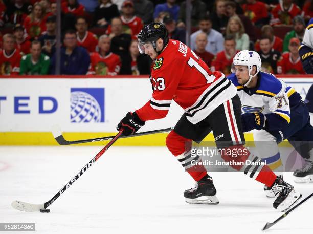 Tomas Jurco of the Chicago Blackhawks controls the puck in front of Vladimir Sobotka of the St. Louis Blues at the United Center on March 18, 2018 in...
