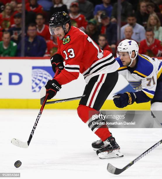 Tomas Jurco of the Chicago Blackhawks controls the puck in front of Vladimir Sobotka of the St. Louis Blues at the United Center on March 18, 2018 in...