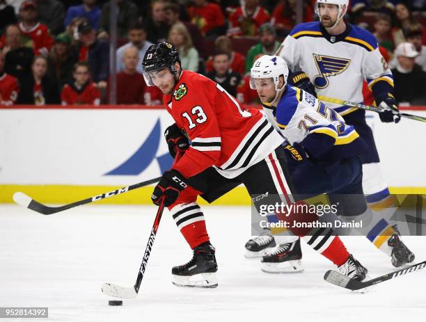 Tomas Jurco of the Chicago Blackhawks controls the puck in front of Vladimir Sobotka of the St. Louis Blues at the United Center on March 18, 2018 in...