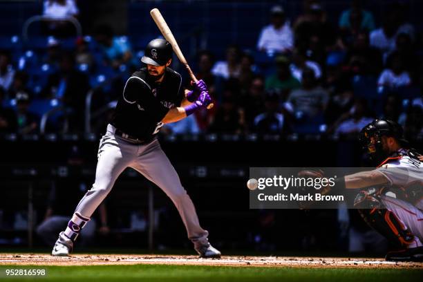 David Dahl of the Colorado Rockies freezes during a pitch from Caleb Smith of the Miami Marlins in the second inning during the game between the...