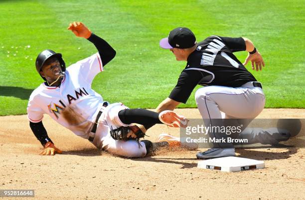 Cameron Maybin of the Miami Marlins is tagged out at second in the seventh inning against the Colorado Rockies at Marlins Park on April 29, 2018 in...
