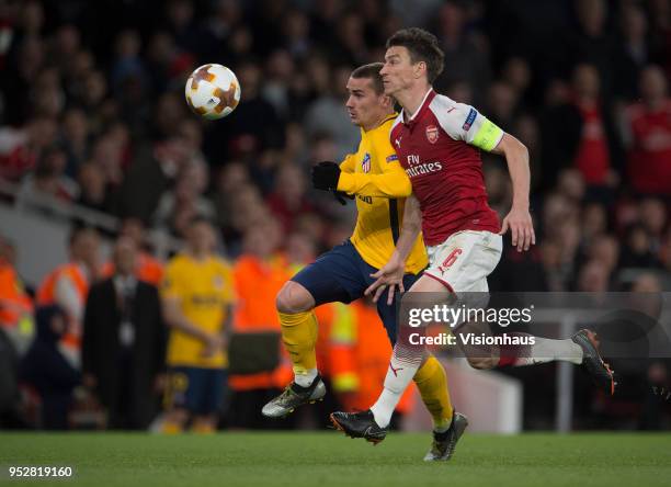 April 26: Antoine Griezmann of Atletico Madrid battles with Laurent Koscielny of Arsenal before going on to score the equaliser for Madrid during the...