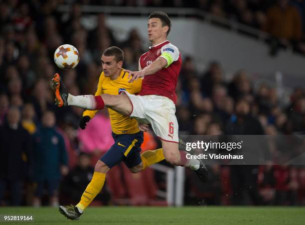 April 26: Antoine Griezmann of Atletico Madrid battles with Laurent Koscielny of Arsenal before going on to score the equaliser for Madrid during the...