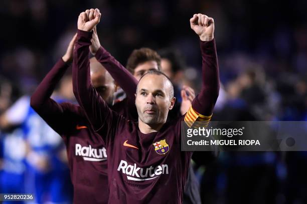 Barcelona's Spanish midfielder Andres Iniesta celebrates after his team won the Spanish league football match against Deportivo Coruna and claimed...