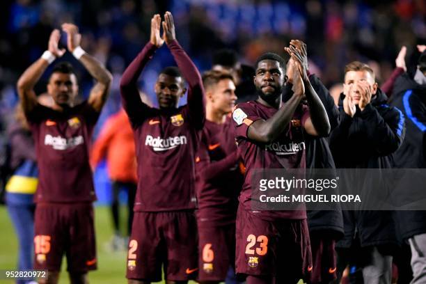 Barcelona's French defender Samuel Umtiti celebrates with teammates after their team won the Spanish league football match against Deportivo Coruna...