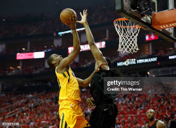 Alec Burks of the Utah Jazz goes up for a shot defended by Nene Hilario of the Houston Rockets in the first half during Game One of the Western...