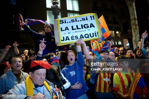 Barcelona football fans celebrate in Barcelona on April 29, 2018 after the club claimed their 25th La Liga title after a thrilling 4-2 victory at...