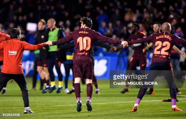 Barcelona's Argentinian forward Lionel Messi celebrates with teammates after winning the Spanish league football match against Deportivo Coruna and...