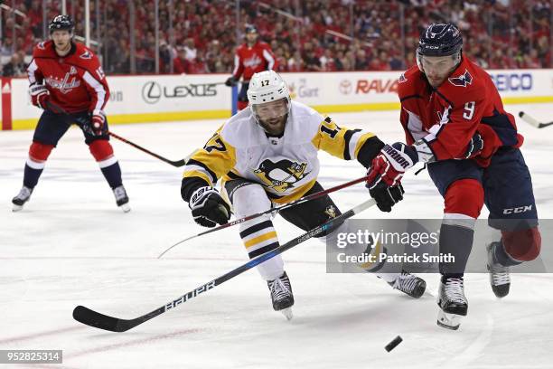 Dmitry Orlov of the Washington Capitals is checked by Bryan Rust of the Pittsburgh Penguins during the second period in Game Two of the Eastern...
