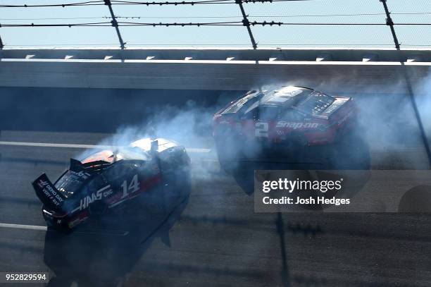 Clint Bowyer, driver of the Haas Automation Demo Day Ford, and Brad Keselowski, driver of the Snap On Ford, have an on track incident during the...