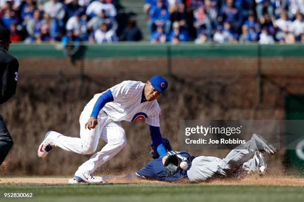 Addison Russell of the Chicago Cubs takes the throw at second as Jonathan Villar of the Milwaukee Brewers slides in the seventh inning of a game at...