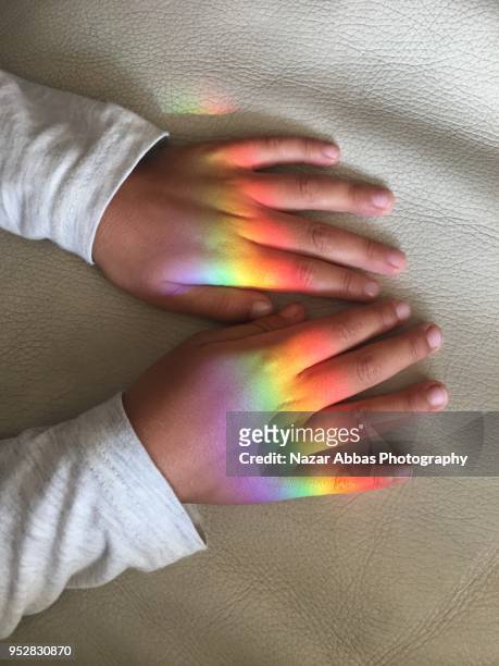 rainbow on kids hand. - nazar abbas foto e immagini stock