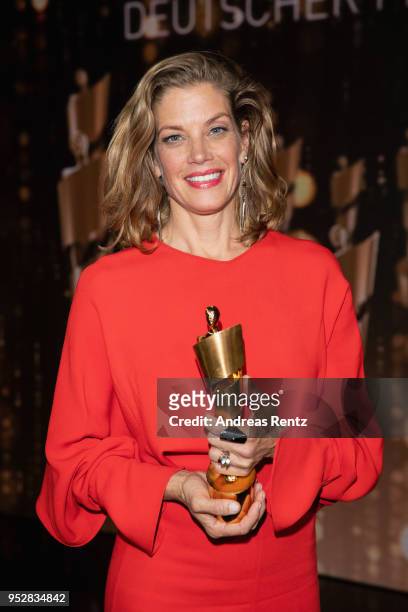 Award winner Marie Baeumer poses on stage during the Lola - German Film Award show at Messe Berlin on April 27, 2018 in Berlin, Germany.