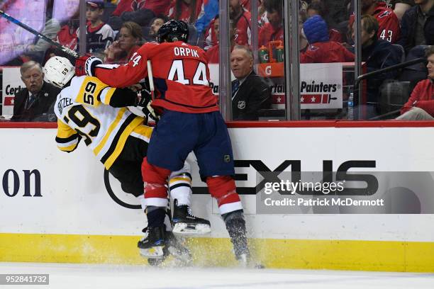 Brooks Orpik of the Washington Capitals and Jake Guentzel of the Pittsburgh Penguins collide in the second period in Game Two of the Eastern...
