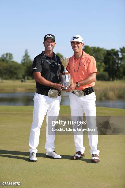 Billy Horschel and Scott Piercy pose with the trophy and commerative belts during the final round of the Zurich Classic at TPC Louisiana on April 29,...