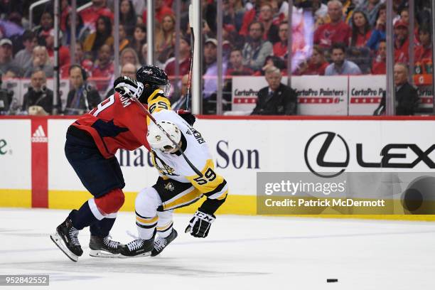 Nicklas Backstrom of the Washington Capitals and Jake Guentzel of the Pittsburgh Penguins collide in the second period in Game Two of the Eastern...