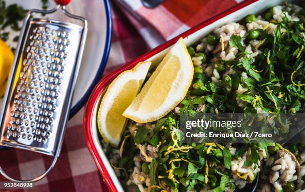 mushroom, pea and lemon risotto, with fresh grated zest - italian parsley stock pictures, royalty-free photos & images