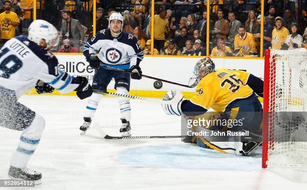Pekka Rinne of the Nashville Predators deflects a pass between Brandon Tanev and Bryan Little of the Winnipeg Jets in Game Two of the Western...