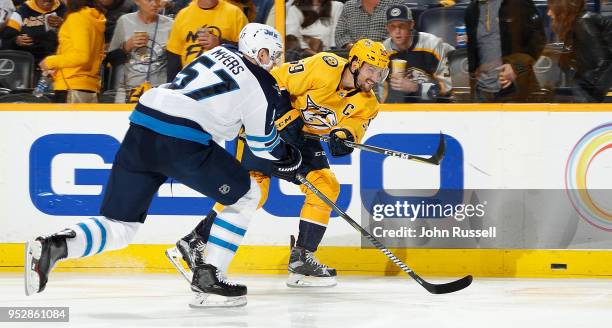 Roman Josi of the Nashville Predators shoots the puck against Tyler Myers of the Winnipeg Jets in Game Two of the Western Conference Second Round...