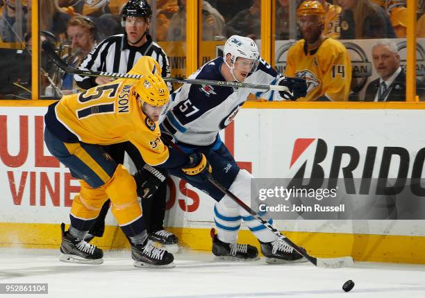 Austin Watson of the Nashville Predators defends against Tyler Myers of the Winnipeg Jets in Game Two of the Western Conference Second Round during...