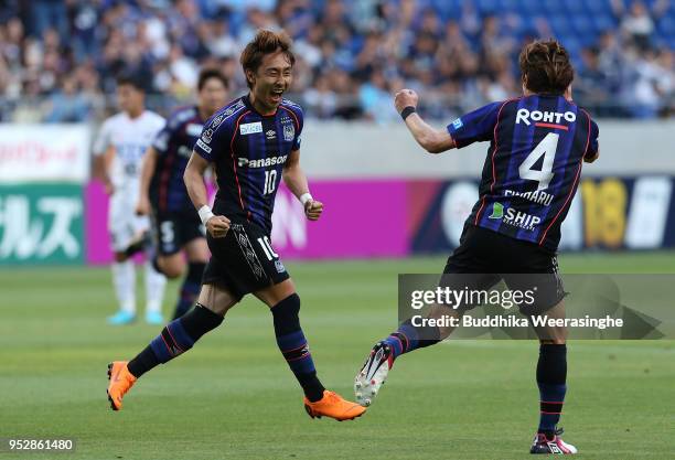 Shu Kurata of Gamba Osaka celebrates scoring the opening goal with his team mate Hiroki Fujiharu during the J.League J1 match between Gamba Osaka and...