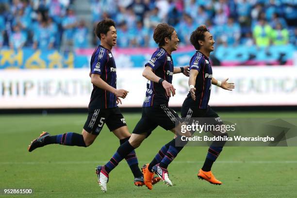 Shu Kurata of Gamba Osaka celebrates scoring the opening goal with his team mates Hiroki Fujiharu and Genta Miura during the J.League J1 match...