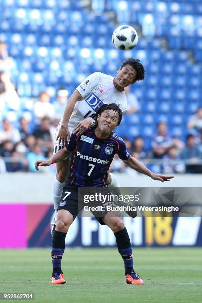 Yoshiki Takahashi of Sagan Tosu and Yasuhito Endo of Gamba Osaka compete for the ball during the J.League J1 match between Gamba Osaka and Sagan Tosu...