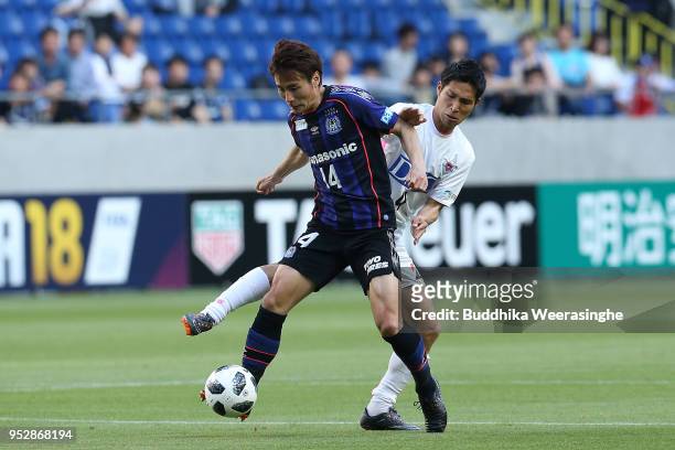 Koki Yonekura of Gamba Osaka and Riki Harakawa of Sagan Tosu compete for the ball during the J.League J1 match between Gamba Osaka and Sagan Tosu at...