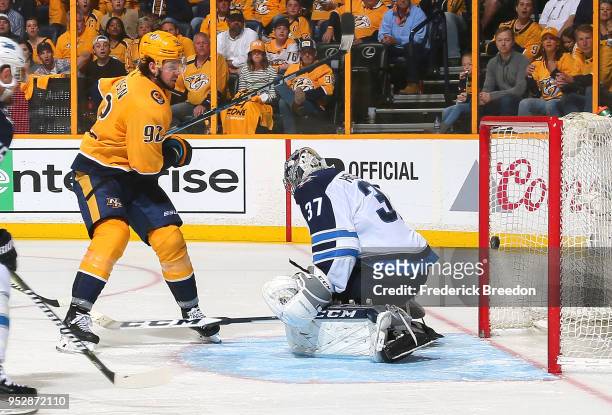 Ryan Johansen of the Nashville Predators scores a goal against goalie Connor Hellebuyck of the Winnipeg Jets during the third period in Game Two of...