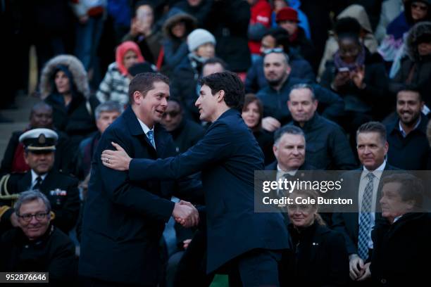 Canadian Prime Minister Justin Trudeau, right, shakes hands with the leader of the Conservative Party of Canada, Andrew Scheer, as they attend a...