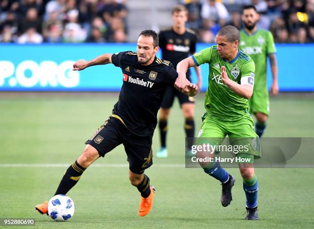 Marco Urena of Los Angeles FC is chased by Osvaldo Alonso of Seattle Sounders during the first half of the inaugural home game at Banc of California...