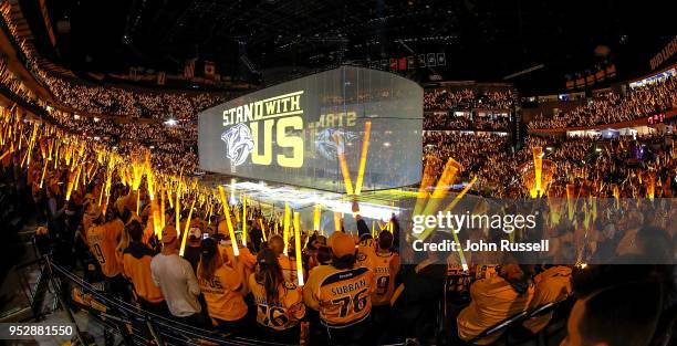 Fans wave their sabers during pregame of Game Two of the Western Conference Second Round between the Nashville Predators and the Winnipeg Jets during...