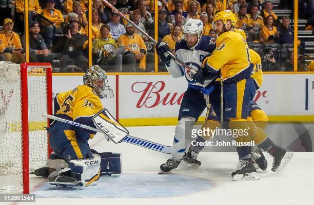 Pekka Rinne of the Nashville Predators makes the save against Blake Wheeler of the Winnipeg Jets as Nick Bonino defends in Game Two of the Western...