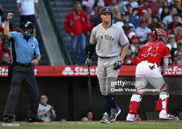 Aaron Judge of the New York Yankees reacts as he is called out on strikes by MLB homeplate umpire Angel Hernandez in the third inning during the MLB...