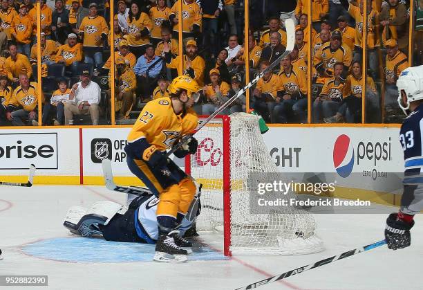 Kevin Fiala of the Nashville Predators scores the game winning goal against goalie Connor Hellebuyck in the second period of overtime in a 5-4...