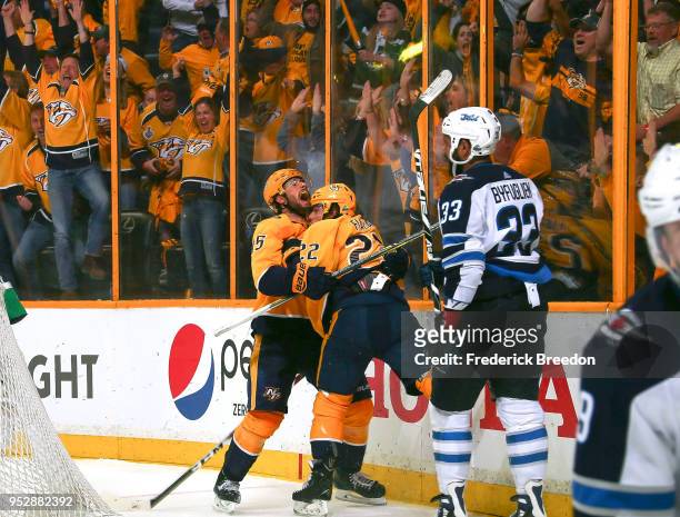 Fans cheer as Craig Smith congratulates teammate Kevin Fiala on scoring the game winning goal against Dustin Byfuglien the of the Winnipeg Jets in...