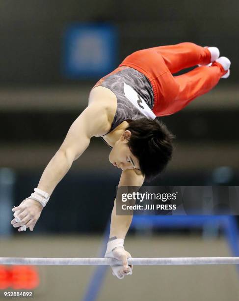 In this picture taken on April 29, 2018 Japanese Kakeru Tanigawa competes in the men's horizontal bar during Japan's National Gymnastics...