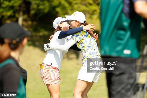 Hina Arakaki and Kana Nagai of Japan hug on the 18th green after the final round of the CyberAgent Ladies Golf Tournament at Grand fields Country...